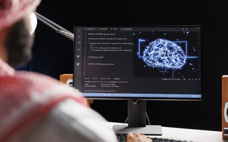 Detailed image of an Arab man using AI and machine learning, ensuring cybersecurity and developing software for computing. monitoring a network of interconnected systems. Close-up shot.